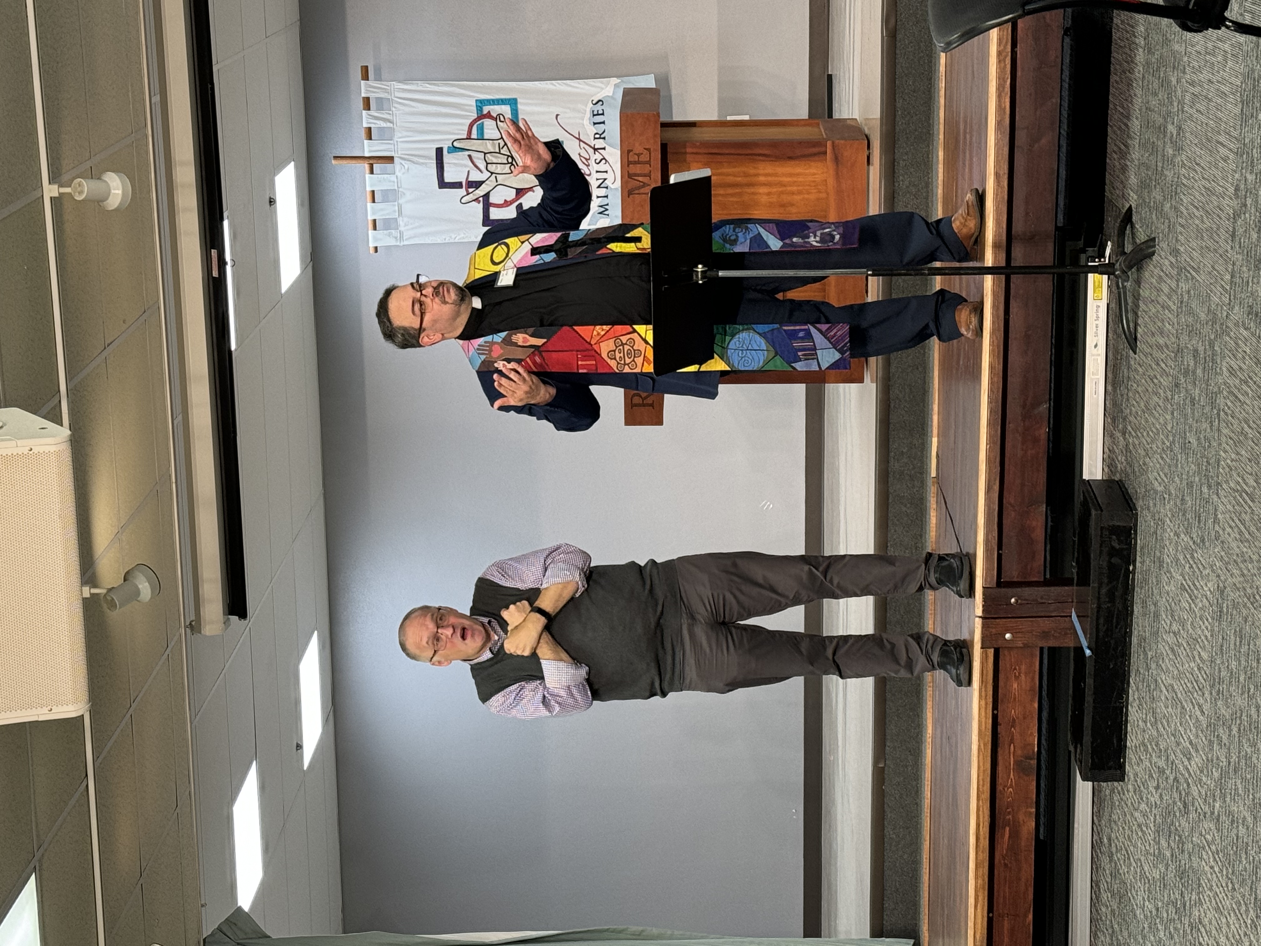 Rev. Dr. Giovanni Arroyo speaking through a sign language interpreter at the 2023 UMCD Conference in Dallas, TX.